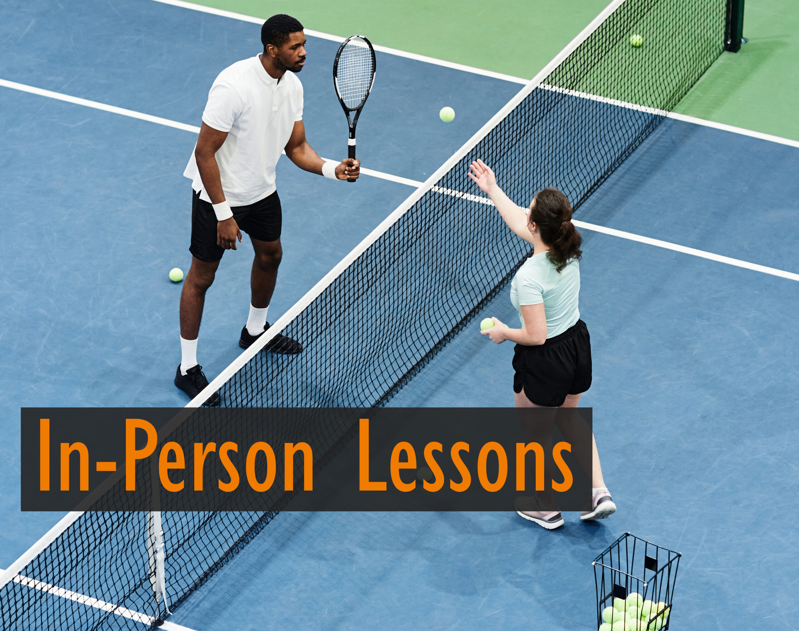 In person lesson image with a man and woman practicing near net play with a basket of tennis balls.