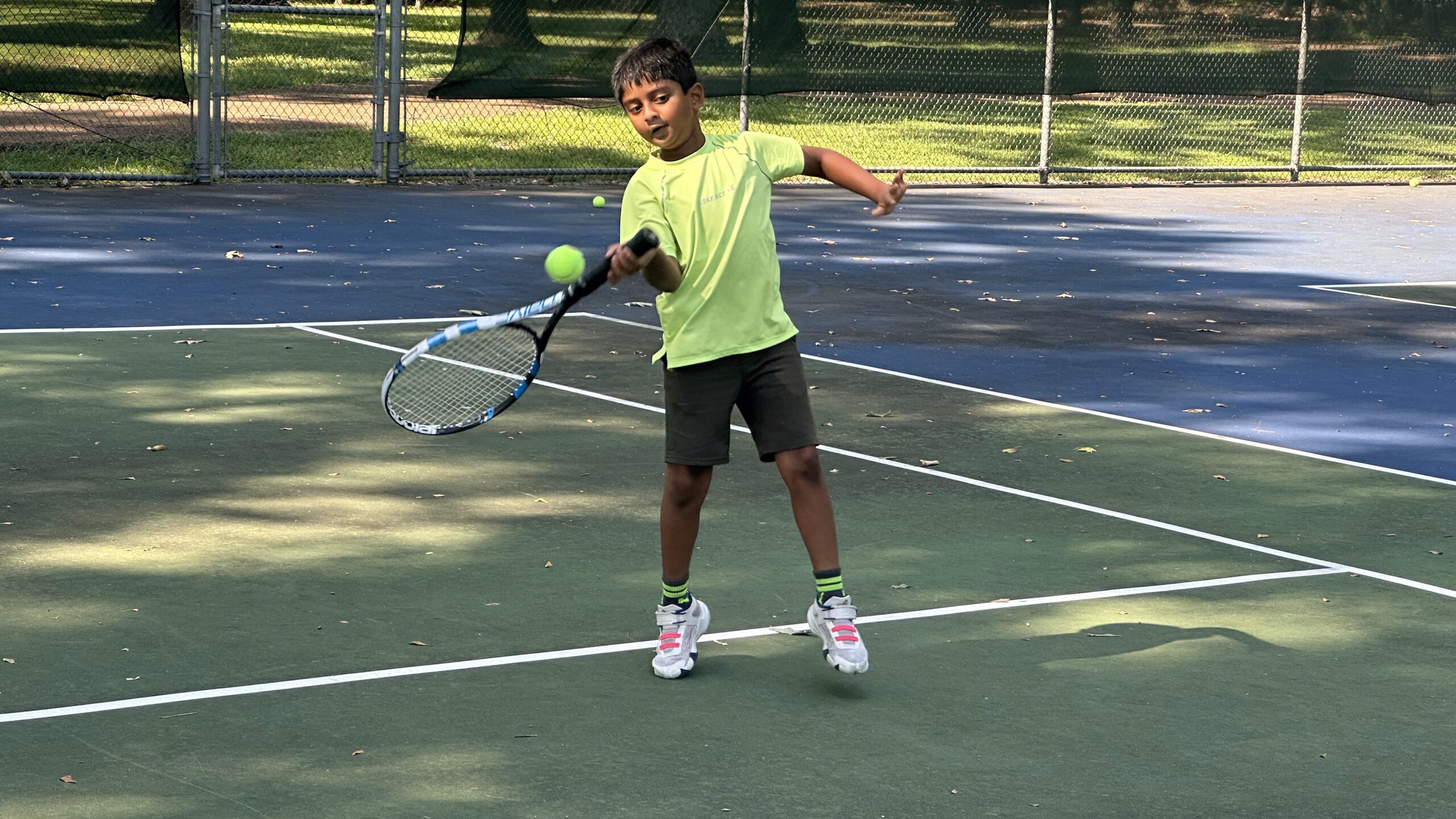 A Small Boy Playing Tennis A Small Boy Playing Tennis